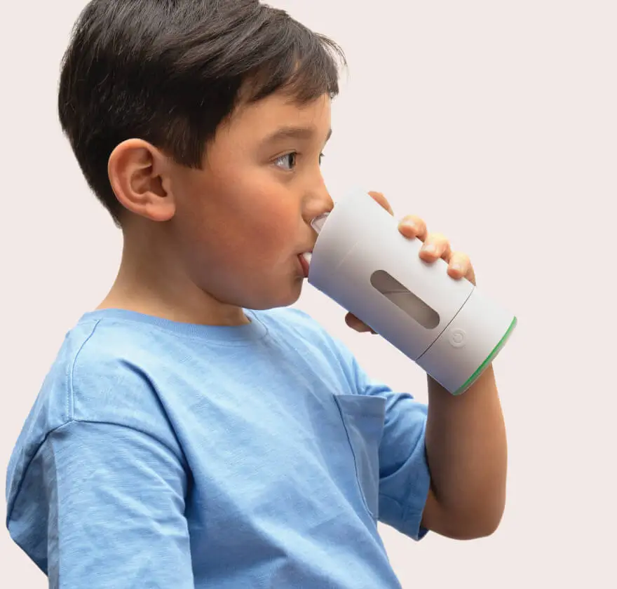 Child drinking from the Earflo device like a sippy cup
